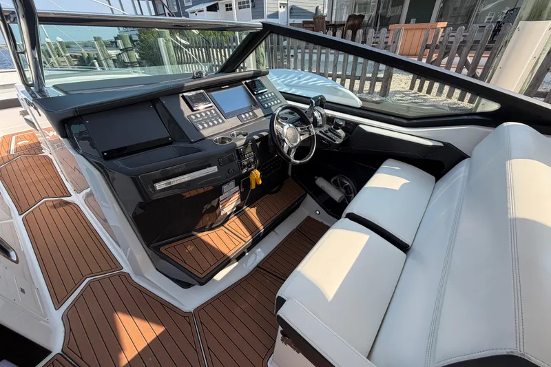 Slide: The Image of 2017 Monterey 378SE Super Express boat interior with modern dashboard and seating. - 18