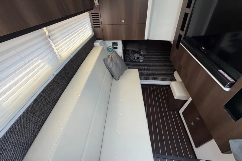 Slide: The Image of Interior of 2017 Monterey 378SE Super Express yacht with modern seating and entertainment area. - 32