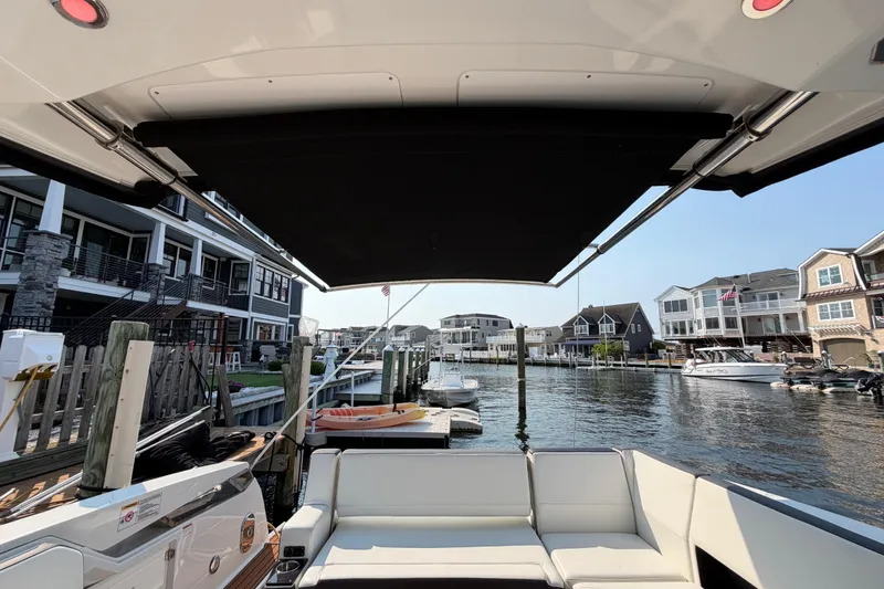 Slide: The Image of 2017 Monterey 378SE Super Express yacht docked in a scenic waterfront marina. - 11