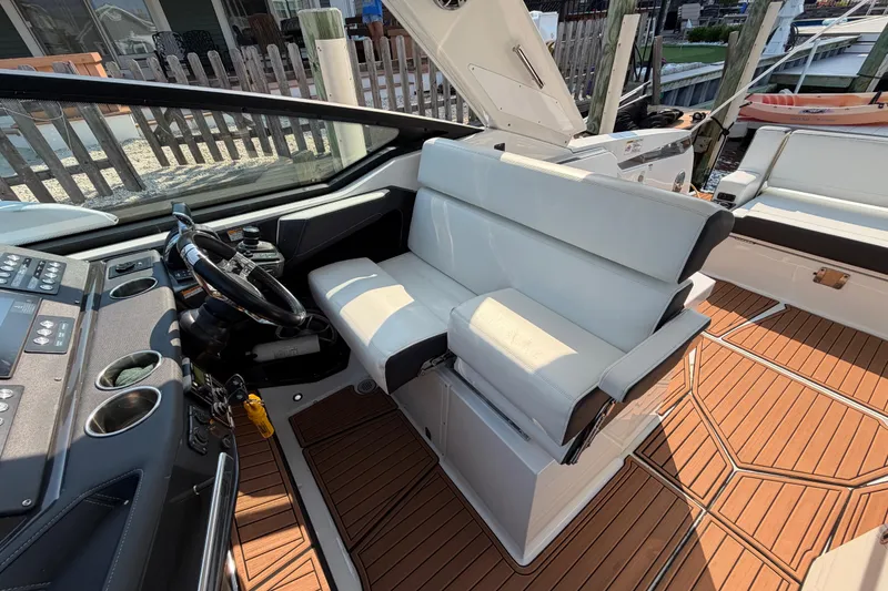 Slide: The Image of 2017 Monterey 378SE Super Express boat interior with white seating and wooden flooring. - 20