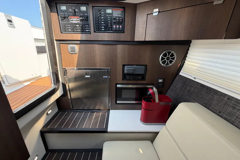 Slide: The Image of Interior of 2017 Monterey 378SE Super Express boat with control panels and seating area. - 37