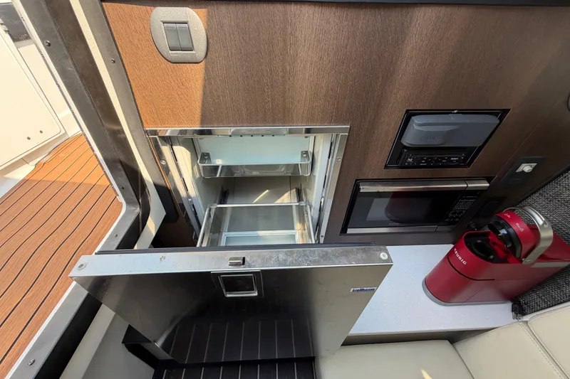Slide: The Image of Interior of 2017 Monterey 378SE Super Express with fridge, microwave, and coffee maker. - 40