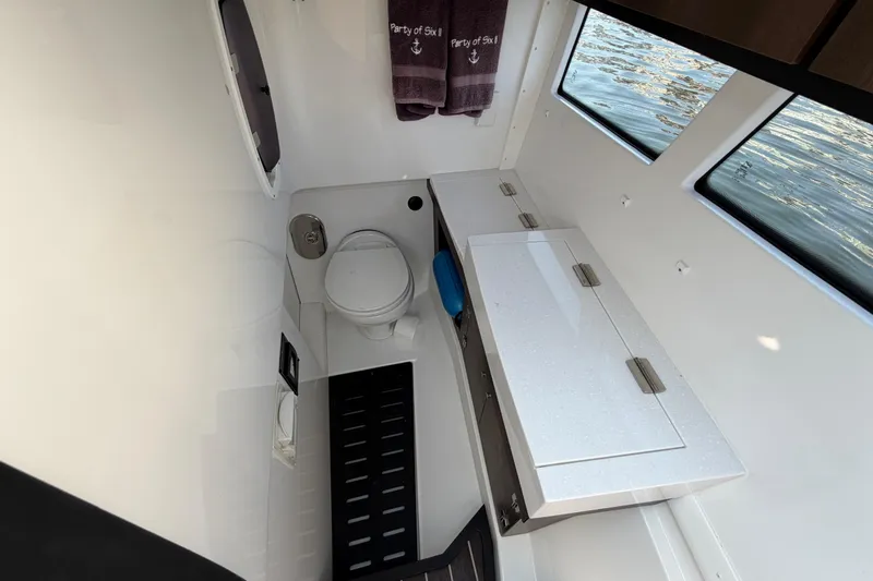 Slide: The Image of Interior of 2017 Monterey 378SE Super Express boat bathroom with toilet and cabinets. - 39
