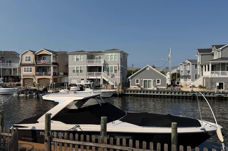 Slide: The Image of 2017 Monterey 378SE Super Express boat docked near waterfront homes. - 2
