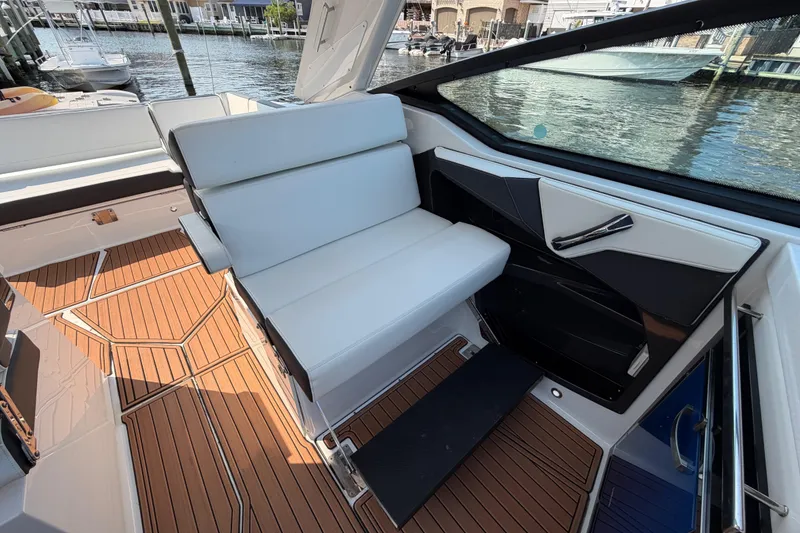Slide: The Image of 2017 Monterey 378SE Super Express boat interior with sleek seating and wood-patterned flooring. - 15