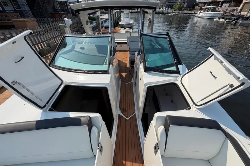 Slide: The Image of 2017 Monterey 378SE Super Express boat with open storage compartments at a marina. - 30