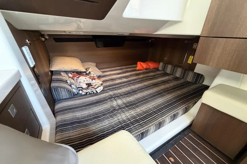 Slide: The Image of Cozy cabin interior of 2017 Monterey 378SE Super Express with striped bedding and wood accents. - 34