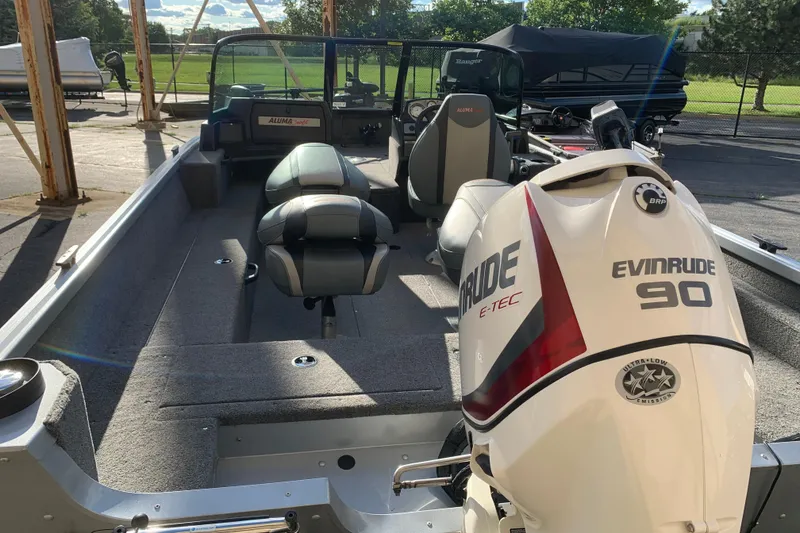 Slide: The Image of 1993 Alumacraft Trophy 175 boat with Evinrude 90 engine, parked outdoors. - 6