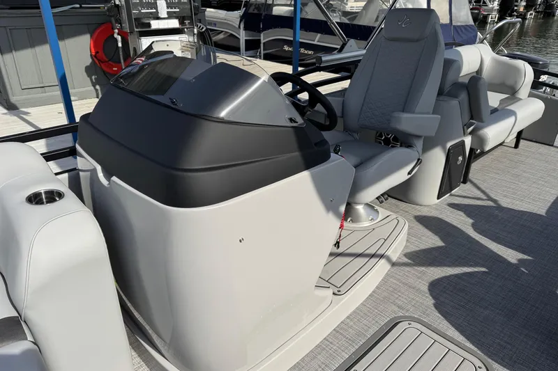 Slide: The Image of 2026 JC Neptoon Sport 23TT DSL boat interior with helm and seating area. - 12