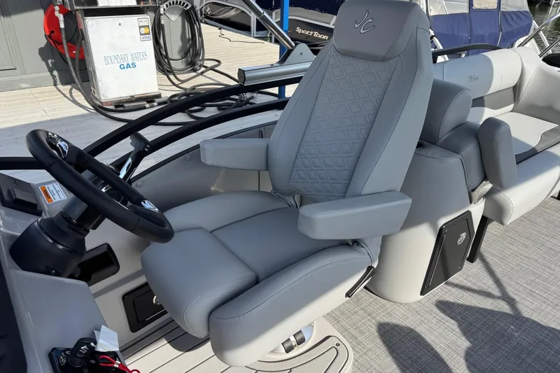 Slide: The Image of 2026 JC Neptoon Sport 23TT DSL boat interior with luxurious captain's chair and steering wheel. - 13