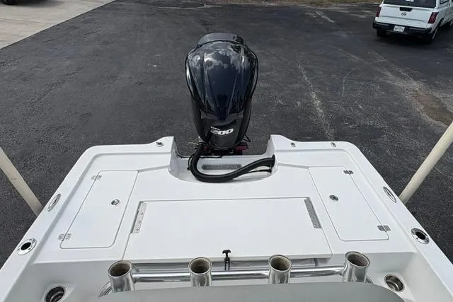 Slide: The Image of 2016 Sportsman Tournament 234 Bay Boat with powerful outboard motor, docked on asphalt surface. - 11