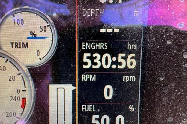 Slide: The Image of Close-up of a 2016 Sportsman Tournament 234 Bay Boat dashboard display showing engine hours and fuel level. - 12