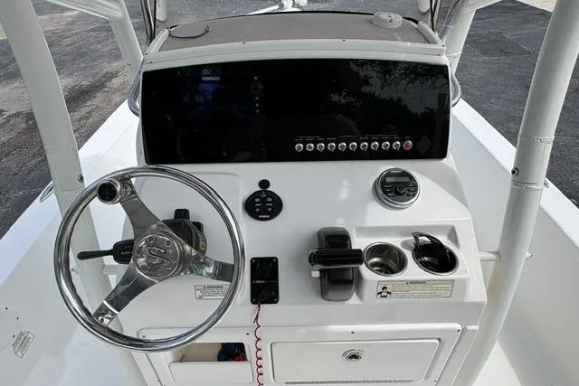 Slide: The Image of 2016 Sportsman Tournament 234 Bay Boat dashboard with steering wheel and control panel. - 13
