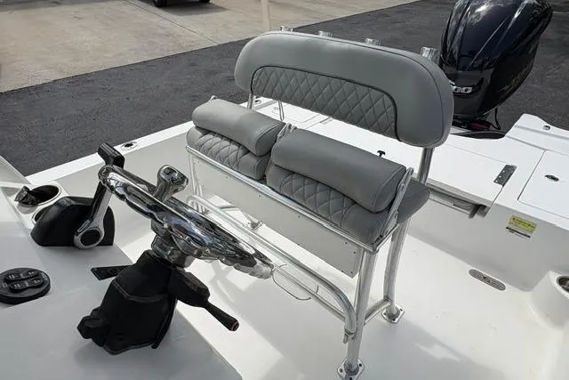 Slide: The Image of 2016 Sportsman Tournament 234 Bay Boat helm with cushioned seating and steering wheel. - 14
