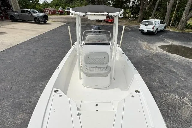 Slide: The Image of 2016 Sportsman Tournament 234 Bay Boat with T-top and seating, parked outdoors. - 16