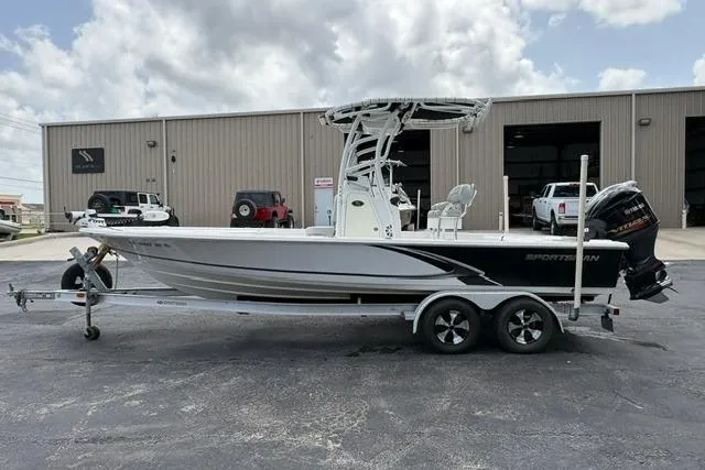Slide: The Image of 2016 Sportsman Tournament 234 Bay Boat on trailer, parked outside a warehouse. - 5
