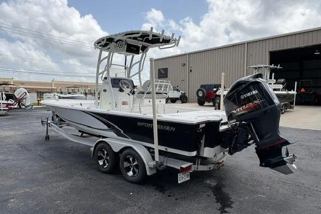 Slide: The Image of 2016 Sportsman Tournament 234 Bay Boat with Yamaha engine on trailer, parked outdoors. - 6
