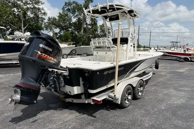 Slide: The Image of 2016 Sportsman Tournament 234 Bay Boat with Yamaha engine on trailer, parked outdoors. - 7