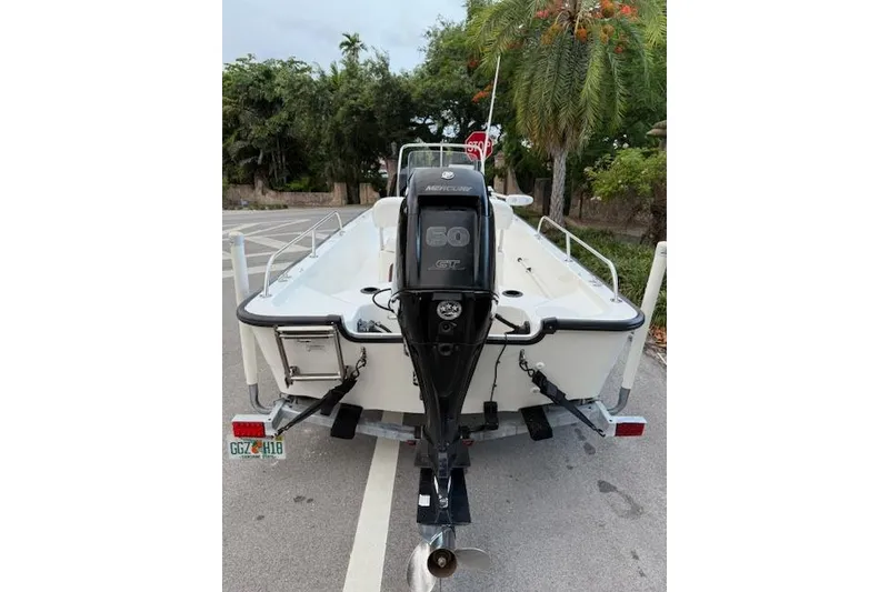 Slide: The Image of 2016 Boston Whaler 150 Montauk boat with Mercury 60 HP engine, parked on trailer. - 10