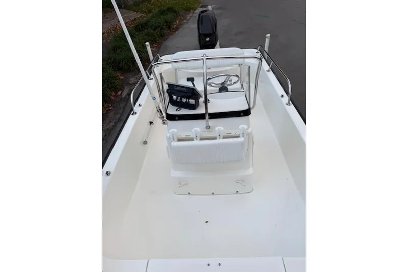 Slide: The Image of 2016 Boston Whaler 150 Montauk boat interior with steering console and seating. - 12