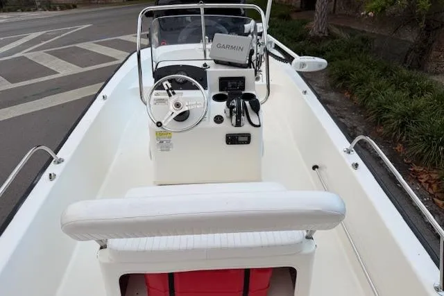 Slide: The Image of 2016 Boston Whaler 150 Montauk boat interior with Garmin navigation system and steering console. - 13