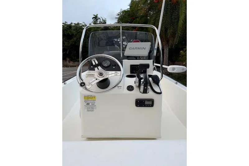 Slide: The Image of 2016 Boston Whaler 150 Montauk boat console with Garmin navigation system and steering wheel. - 14