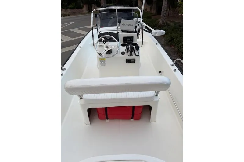 Slide: The Image of 2016 Boston Whaler 150 Montauk boat interior with steering console and seating. - 16