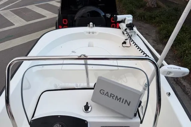 Slide: The Image of 2016 Boston Whaler 150 Montauk boat with Garmin navigation system, docked near a road. - 18