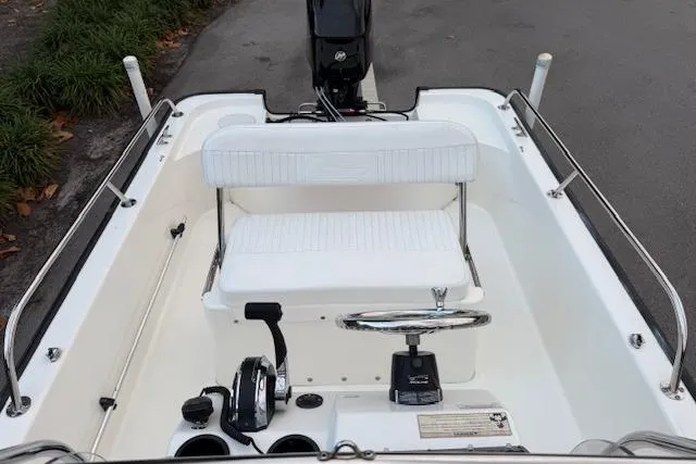 Slide: The Image of 2016 Boston Whaler 150 Montauk boat interior with steering wheel and seating. - 21