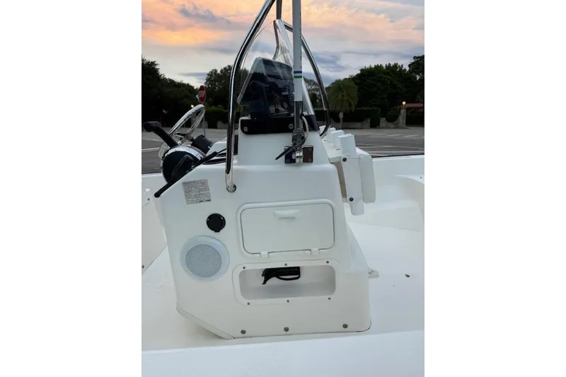 Slide: The Image of 2016 Boston Whaler 150 Montauk boat console at sunset, featuring steering and controls. - 23