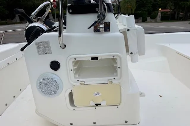 Slide: The Image of 2016 Boston Whaler 150 Montauk boat console with storage compartment and steering wheel. - 24