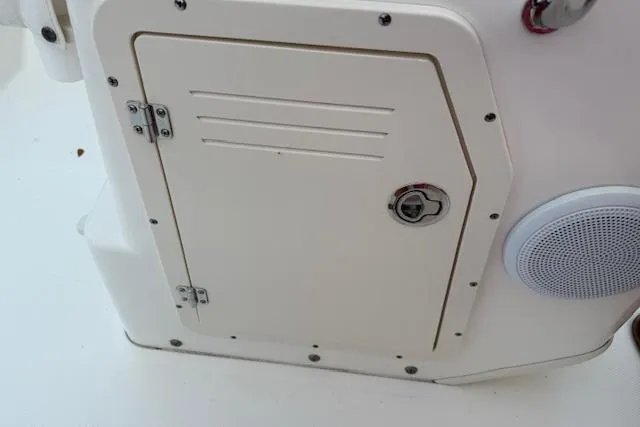 Slide: The Image of 2016 Boston Whaler 150 Montauk boat compartment with speaker and secure latch. - 25