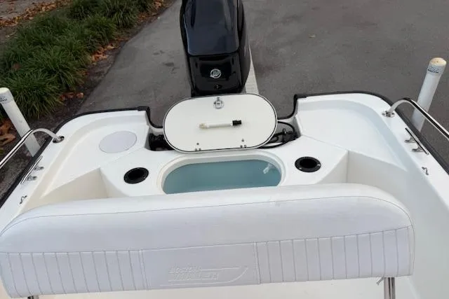 Slide: The Image of 2016 Boston Whaler 150 Montauk boat interior with seating and storage compartments. - 27
