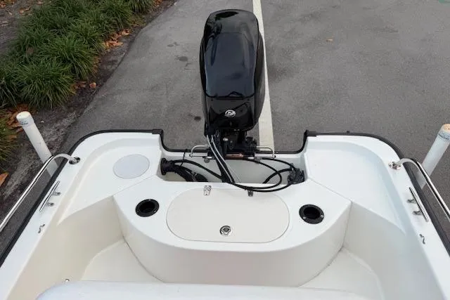 Slide: The Image of 2016 Boston Whaler 150 Montauk boat stern view with outboard motor and seating. - 28