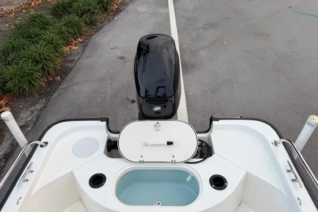 Slide: The Image of 2016 Boston Whaler 150 Montauk boat stern view with motor and storage compartments. - 29