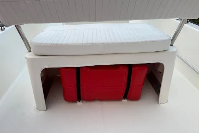 Slide: The Image of 2016 Boston Whaler 150 Montauk boat seat with red storage container underneath. - 30