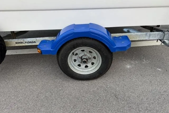 Slide: The Image of Trailer wheel with blue fender for 2016 Boston Whaler 150 Montauk in Miami, Florida. - 31