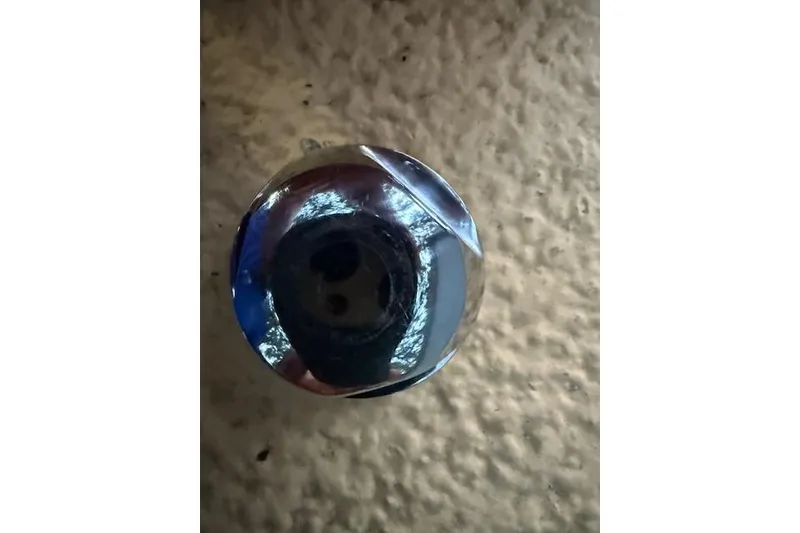 Slide: The Image of Close-up of a shiny metal knob on a 2016 Boston Whaler 150 Montauk boat. - 34