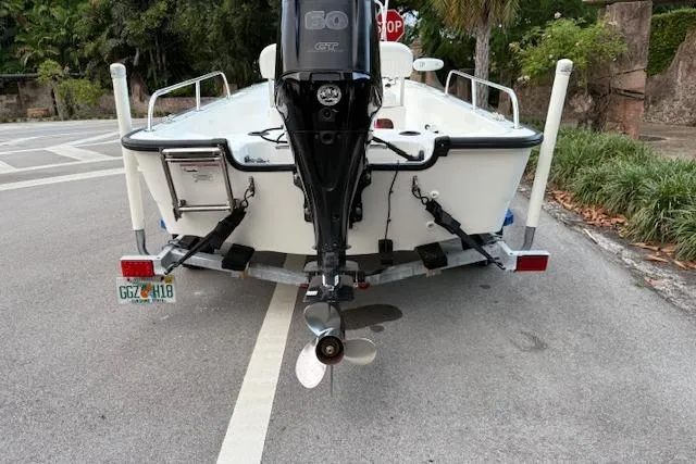 Slide: The Image of 2016 Boston Whaler 150 Montauk boat on trailer, rear view with outboard motor. - 9