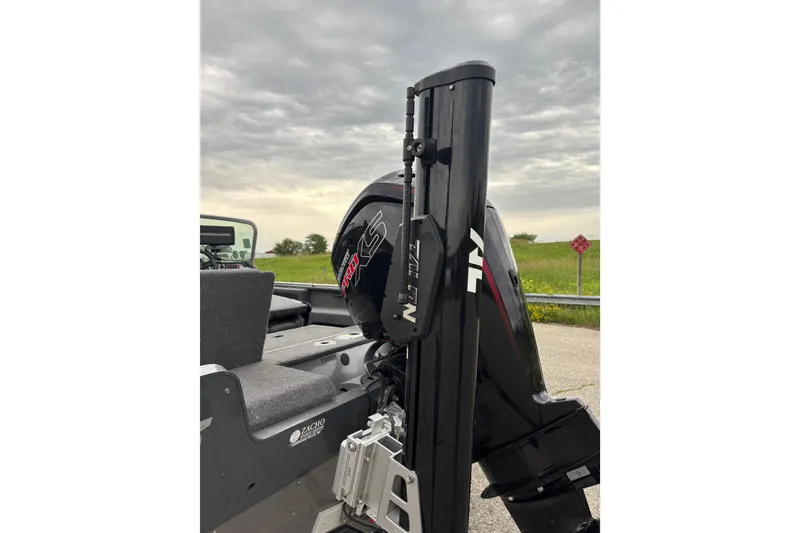 Slide: The Image of 2018 Lund 1775 Impact XS boat with Talon anchor system, parked under cloudy sky. - 5