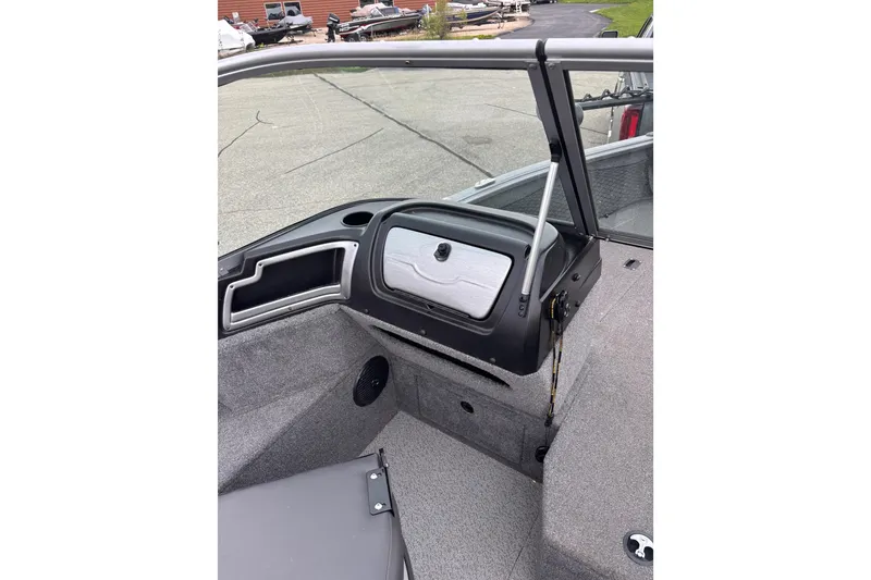 Slide: The Image of 2018 Lund 1775 Impact XS boat interior with dashboard and seating area. - 7