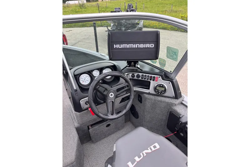 Slide: The Image of 2018 Lund 1775 Impact XS boat dashboard with Humminbird fish finder and steering wheel. - 8