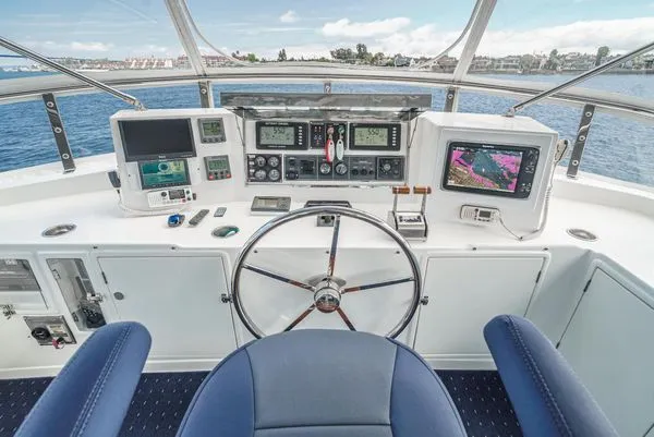 Slide: The Image of Helm of a yacht with modern navigation equipment and blue seating. - 13