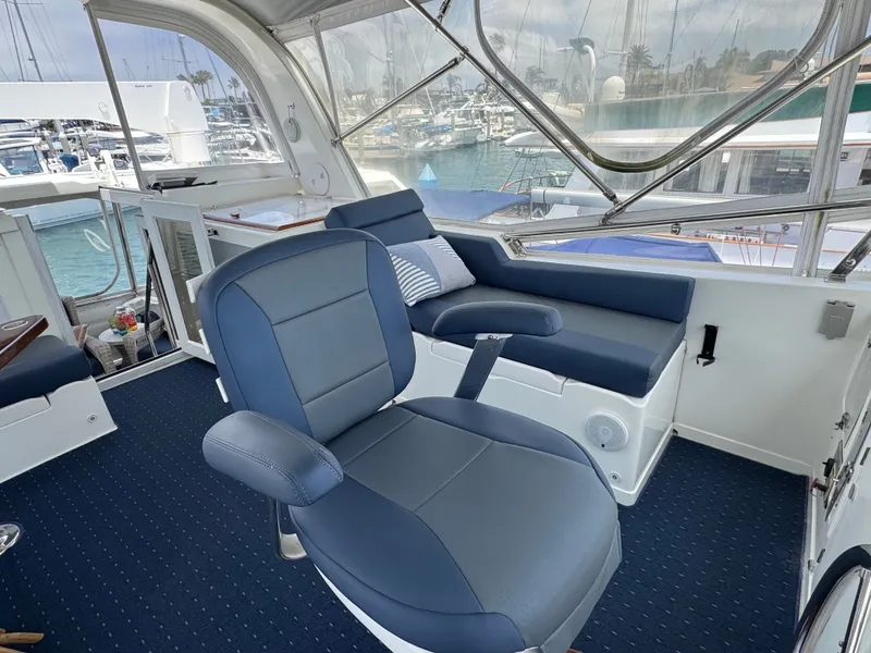 Slide: The Image of Interior of a yacht with blue seating and a view of the marina. - 21