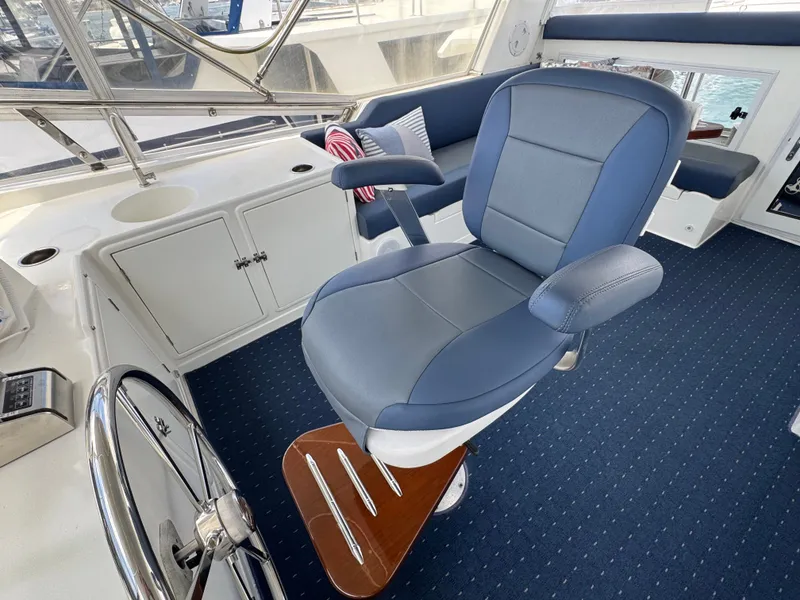 Slide: The Image of Helm station with blue captain's chair and steering wheel on blue carpeted floor. - 24