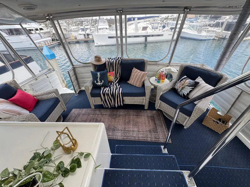 Slide: The Image of The image shows a yacht deck with wicker furniture and cushions on a blue carpet. - 29