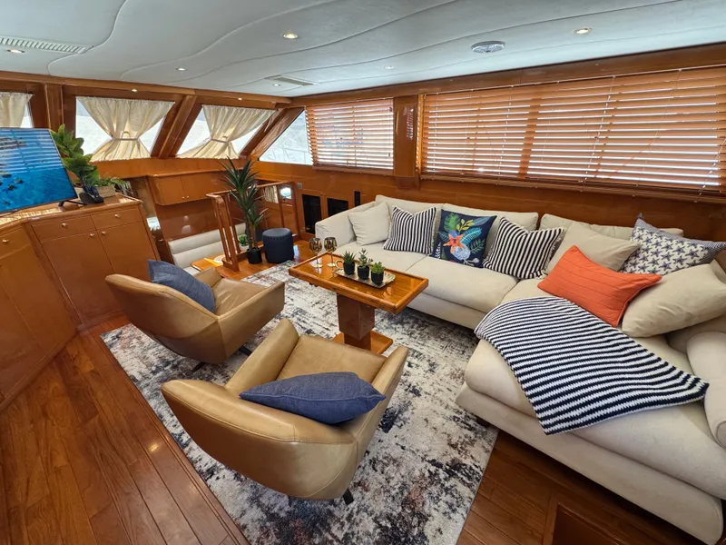 Slide: The Image of Interior of a luxurious yacht with comfortable sofas and chairs, wooden floors, and large windows. - 31