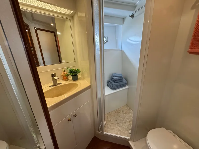 Slide: The Image of Bathroom with sink, shower, and toilet inside a boat. - 43