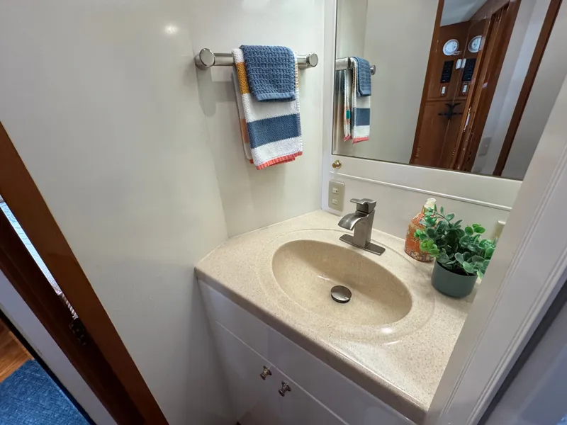 Slide: The Image of A sleek bathroom with a sink, towel rack, and mirror. - 44