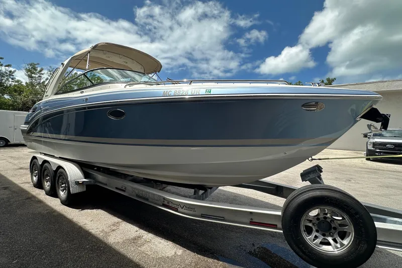 Slide: The Image of 2018 Formula 290 Bowrider boat on trailer under blue sky. - 1